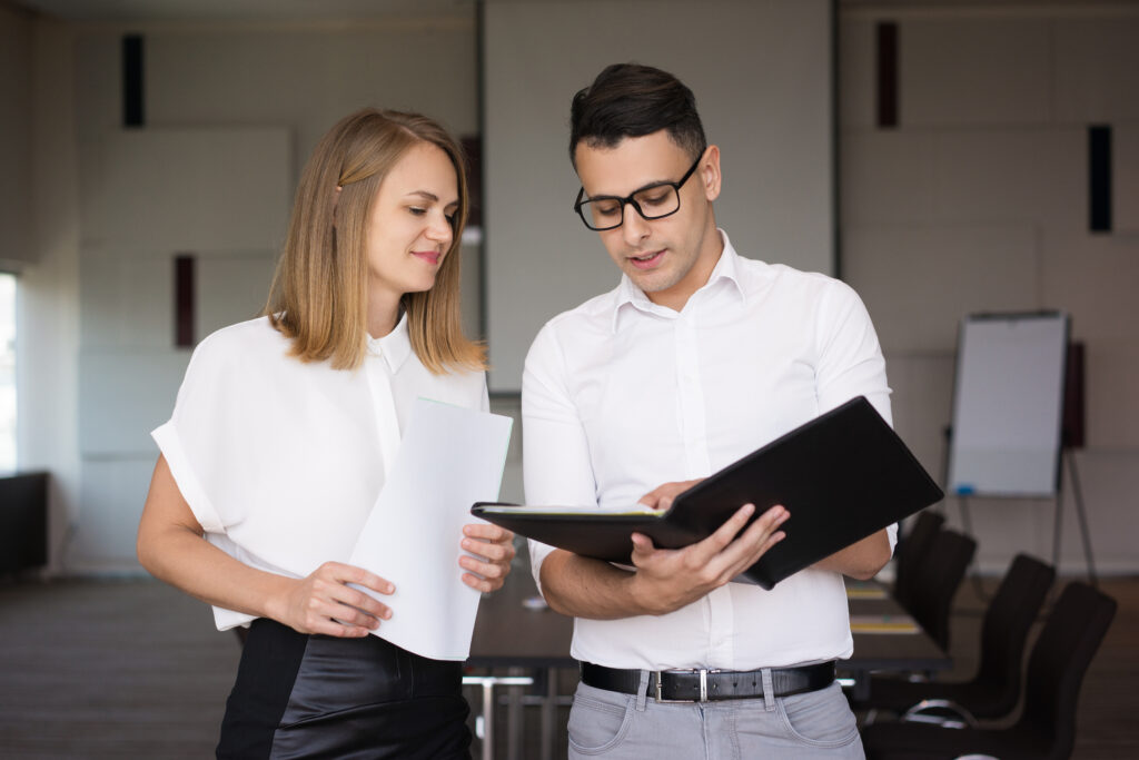 confident executive explaining documents to secretary confident executive explaining documents to secretary